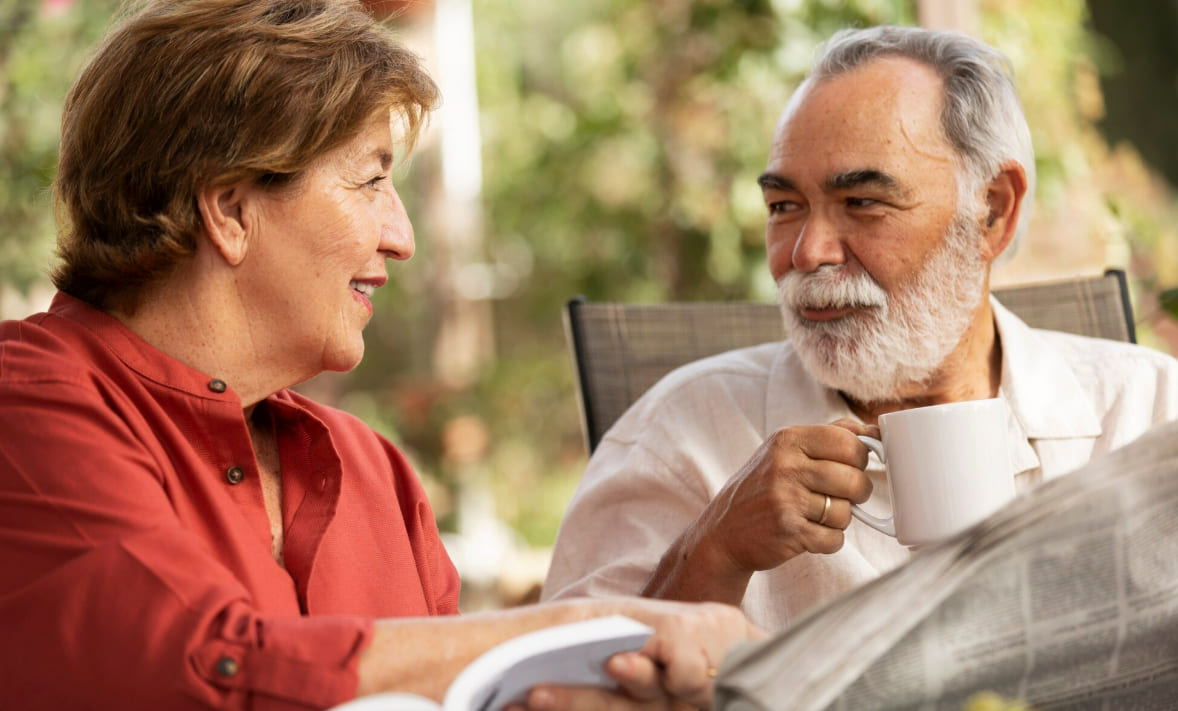 Mature seniors sharing a calm friendship-first conversation