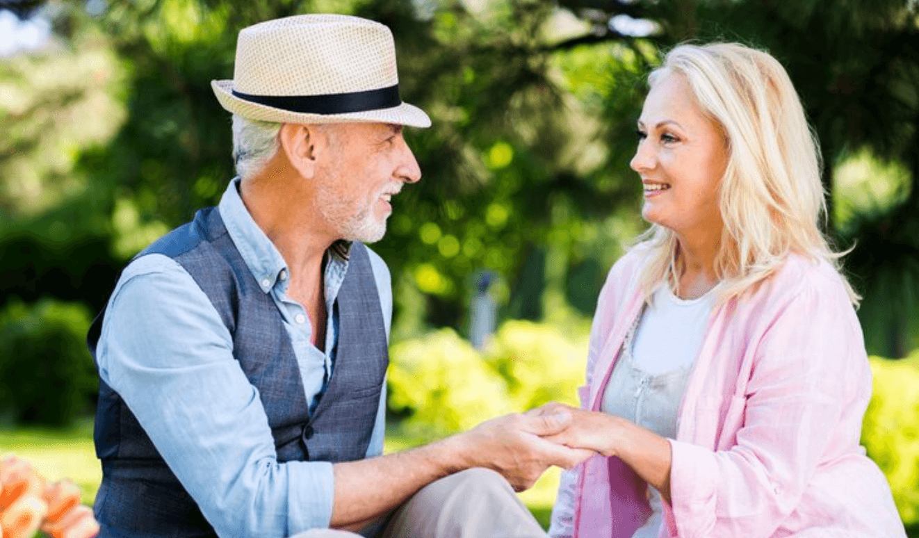 Mature couple outdoors enjoying a relaxed local conversation
