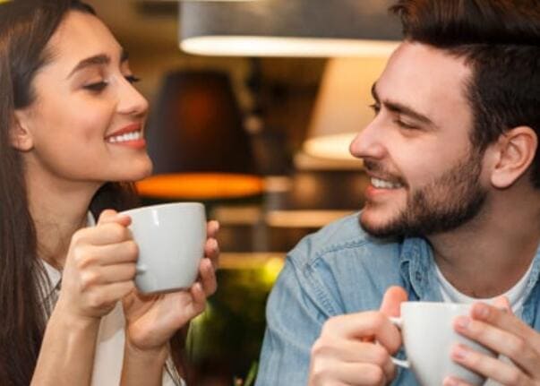 Two people talking over coffee in a cafe